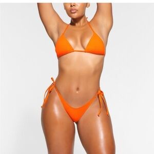 Skims dipped bottom size small. Top is size large. Never worn. Tags attached